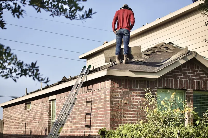 Professional roofer working on a residential roof in Rockaway Valley